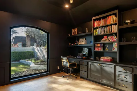 a spacious bedroom with a bed and a fireplace