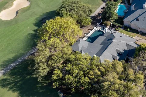 an aerial view of a house with a yard