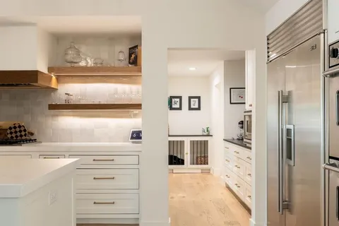 a kitchen with granite countertop a sink cabinets and window