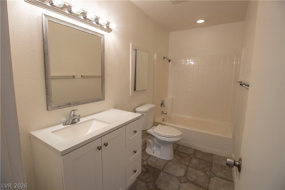 119 West Victory Road Henderson, NV 89015 - Photo 21 of 26 A well-appointed bathroom featuring a contemporary vanity, large mirror, and full-size tub with shower.