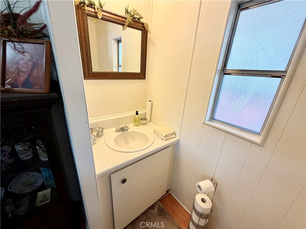 12582 2nd Street, Unit 65 Yucaipa, CA 92399 - Photo 12 of 21 a bathroom with a sink and mirror with toilet