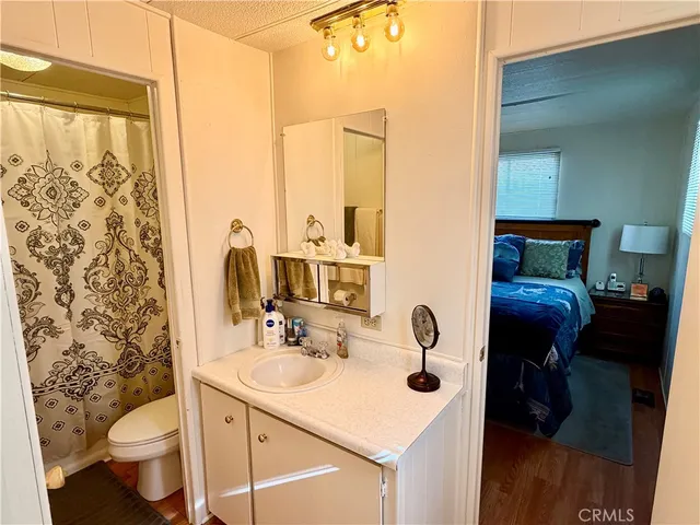 a bathroom with a sink toilet and mirror