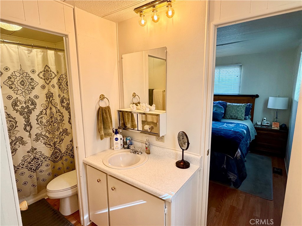 12582 2nd Street, Unit 65 Yucaipa, CA 92399 - Photo 18 of 21 a bathroom with a sink toilet and mirror