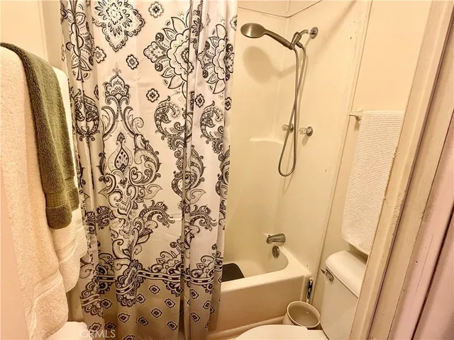 a bathroom with a shower curtain and a shower curtain