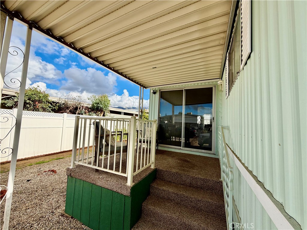 12582 2nd Street, Unit 65 Yucaipa, CA 92399 - Photo 2 of 21 a view of a balcony with wooden floor and fence