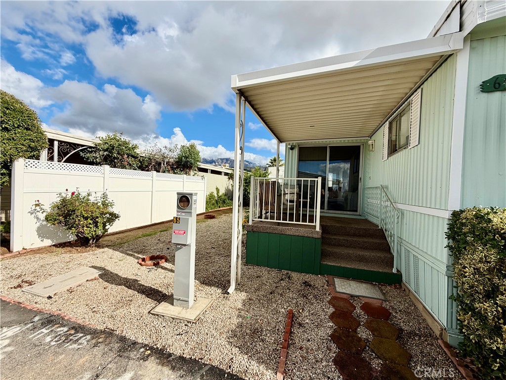 12582 2nd Street, Unit 65 Yucaipa, CA 92399 - Photo 3 of 21 a view of a porch with furniture and a yard
