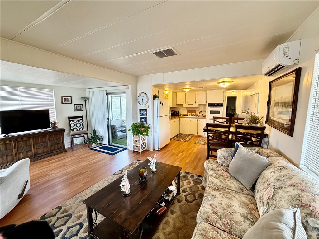 12582 2nd Street, Unit 65 Yucaipa, CA 92399 - Photo 5 of 21 a living room with furniture fireplace and a flat screen tv