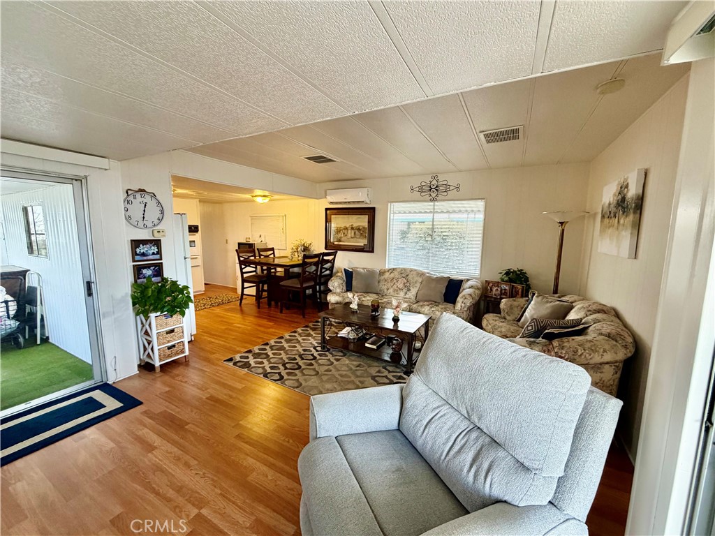 12582 2nd Street, Unit 65 Yucaipa, CA 92399 - Photo 6 of 21 a living room with furniture rug and wooden floor