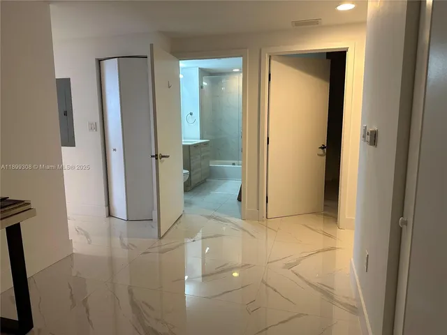 a bedroom with a bed and glass door