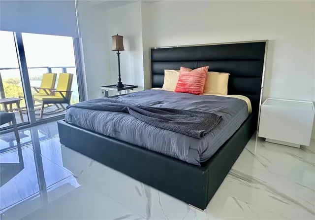 a room with wooden floor and pool table