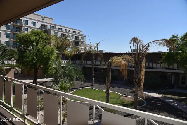 a view of balcony with two potted plants