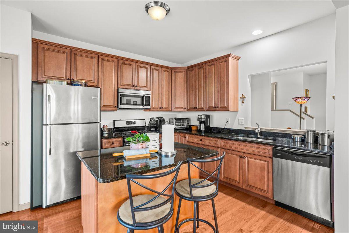 14 Indiana Circle Lemoyne, PA 17043 - Photo 12 of 30 a kitchen with stainless steel appliances granite countertop a refrigerator a stove a sink dishwasher and a dining table with wooden cabinet