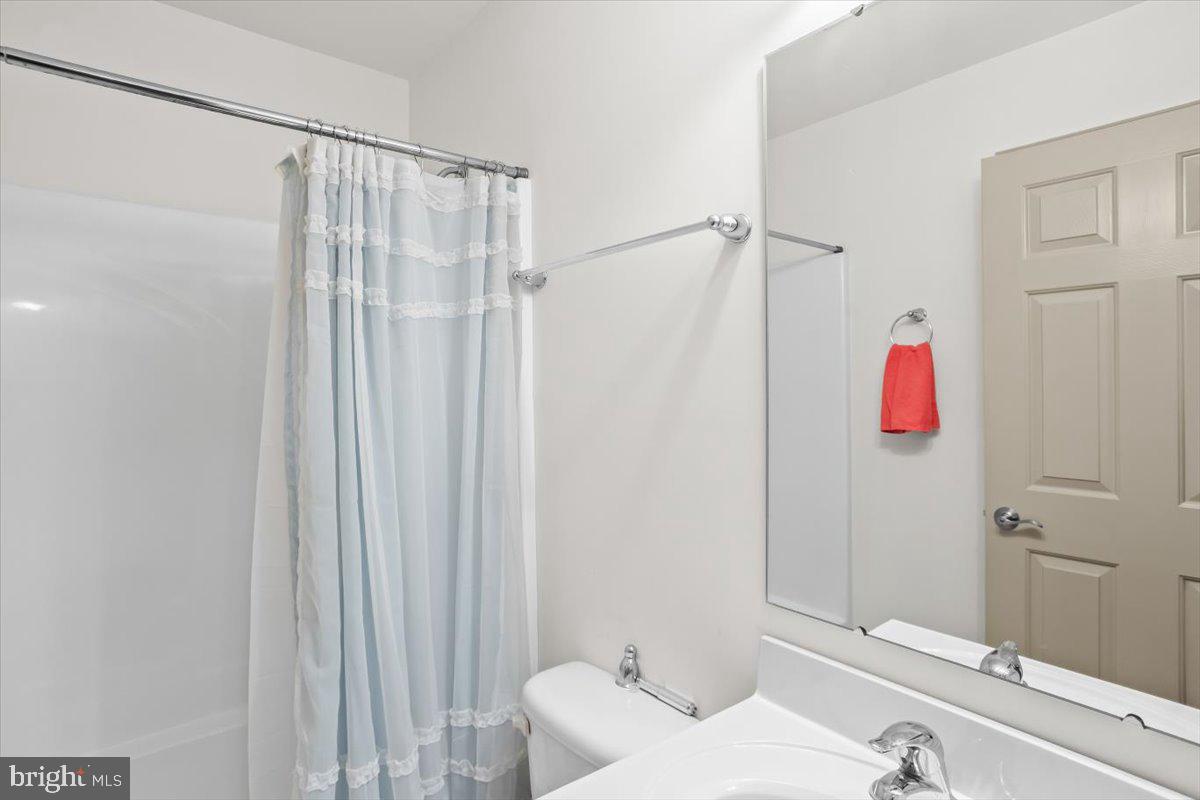 14 Indiana Circle Lemoyne, PA 17043 - Photo 20 of 30 a bathroom with a sink and a shower curtain