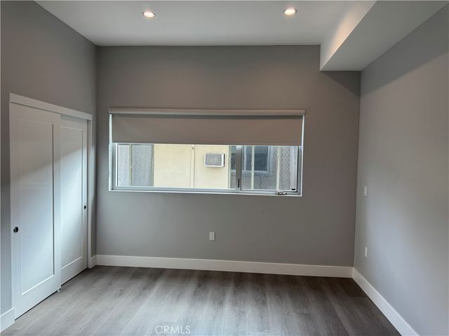 a front view of a building with trees