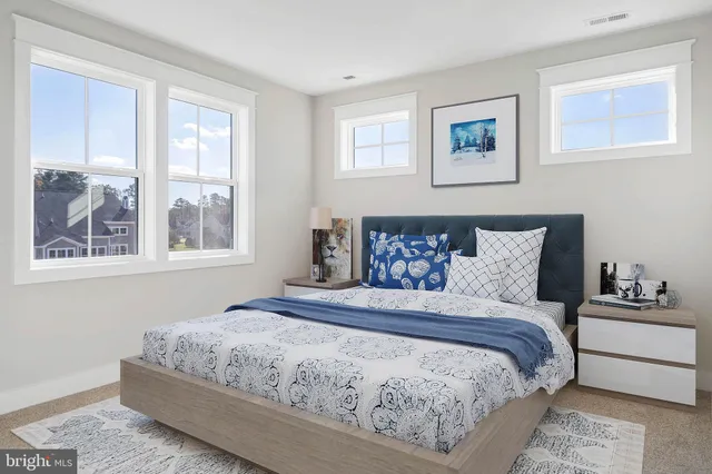 a bedroom with a large bed and a window