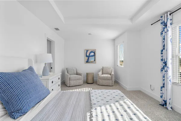 a bedroom with furniture and a rug