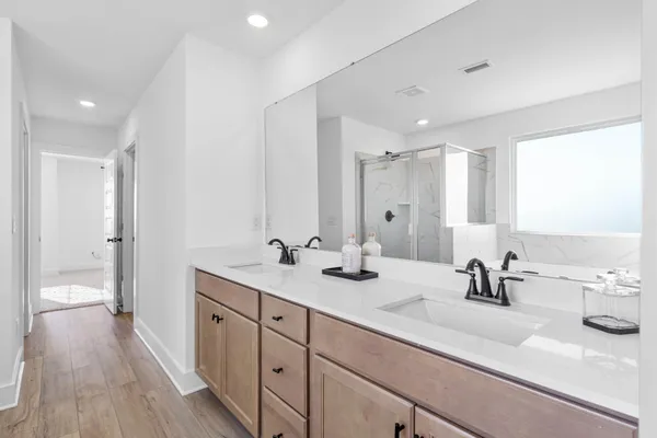 a bathroom with a double vanity sink and mirror
