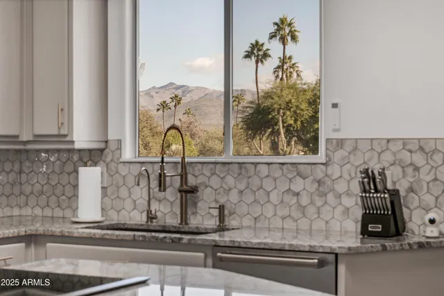 a dining room with stainless steel appliances granite countertop wooden floor a table and chairs