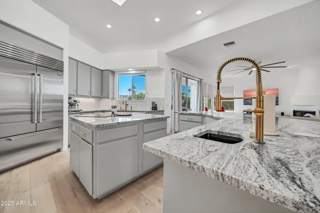 a bathroom with a granite countertop sink and a mirror