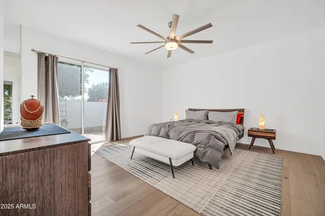 a view of a white house with a yard and potted plants