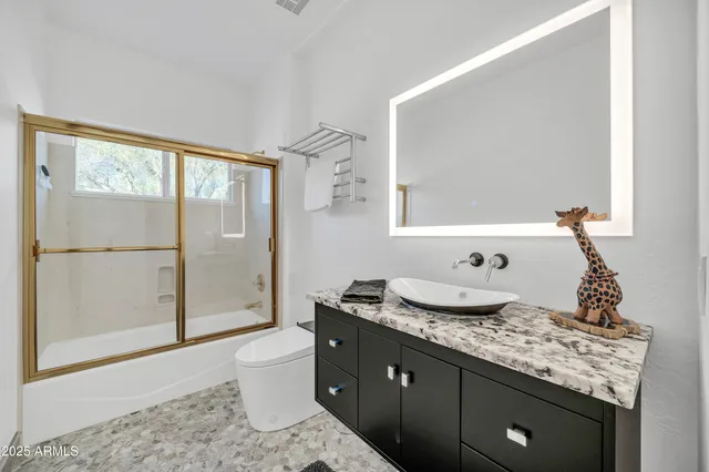 a bed sitting in a bedroom next to a window