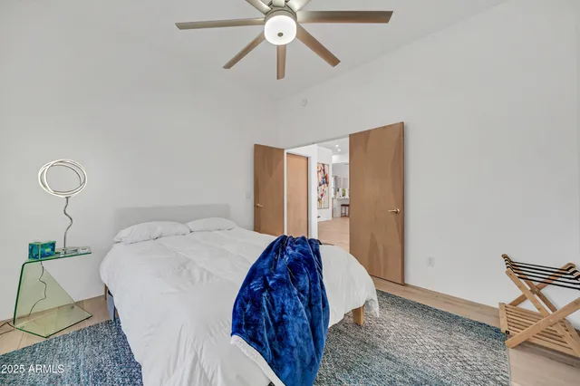 a bathroom with a granite countertop sink a toilet a mirror and shower