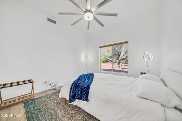 a bedroom with a bed and cabinets