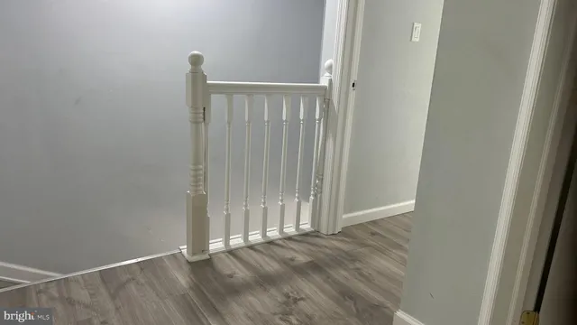 an empty room with wooden floor and a window