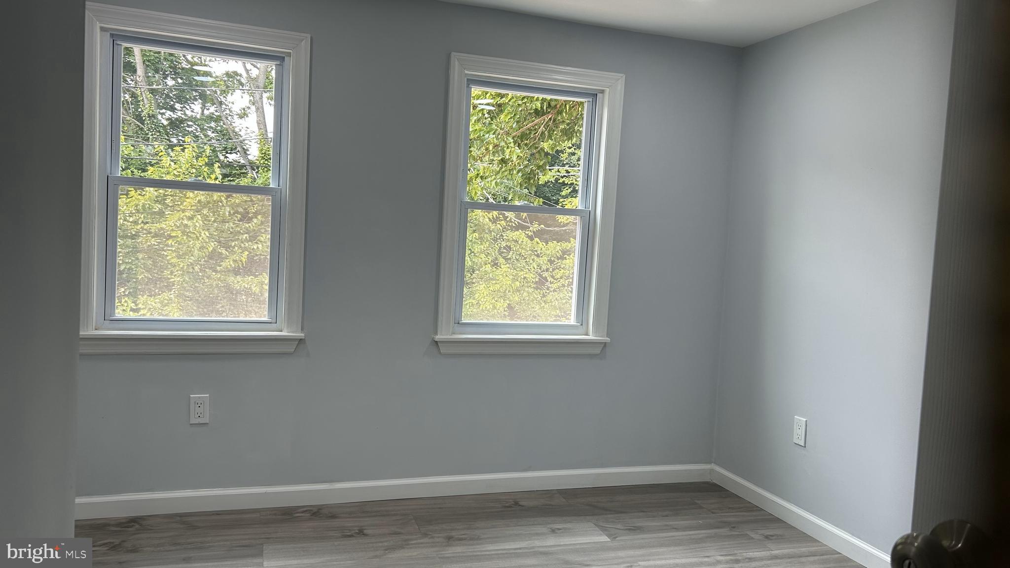 69 Carpenter Street Salem, NJ 08079 - Photo 20 of 29 an empty room with wooden floor and windows