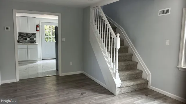 a view of entryway and hall with wooden floor
