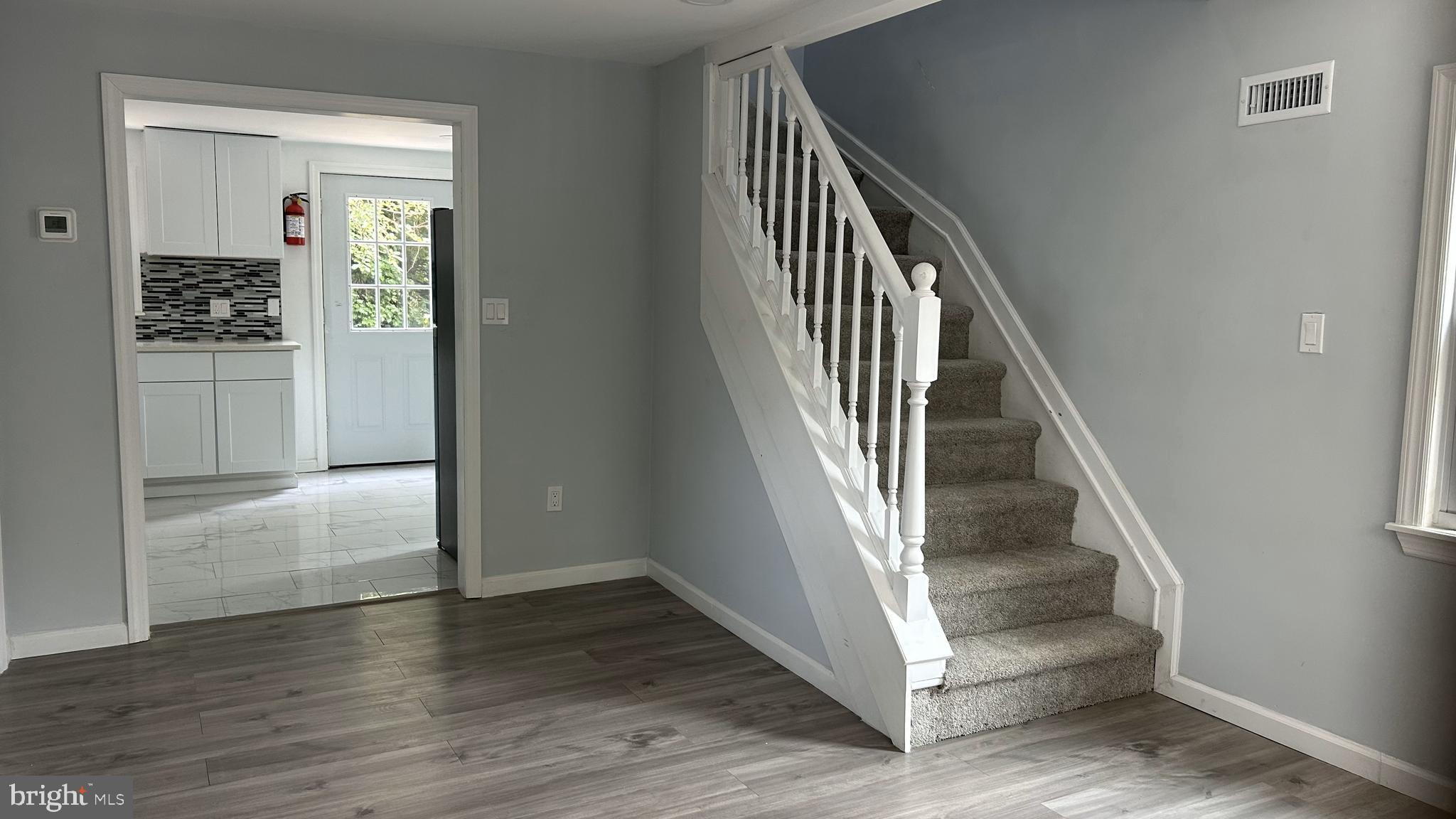 69 Carpenter Street Salem, NJ 08079 - Photo 3 of 29 a view of entryway and hall with wooden floor