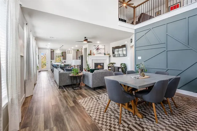 a living room with furniture a table and kitchen view