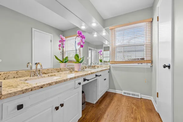 a bathroom with a sink vanity granite and a mirror