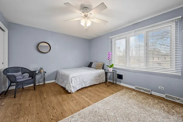 a bedroom with a bed and a chair