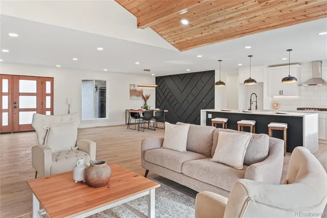 a living room with furniture and kitchen view