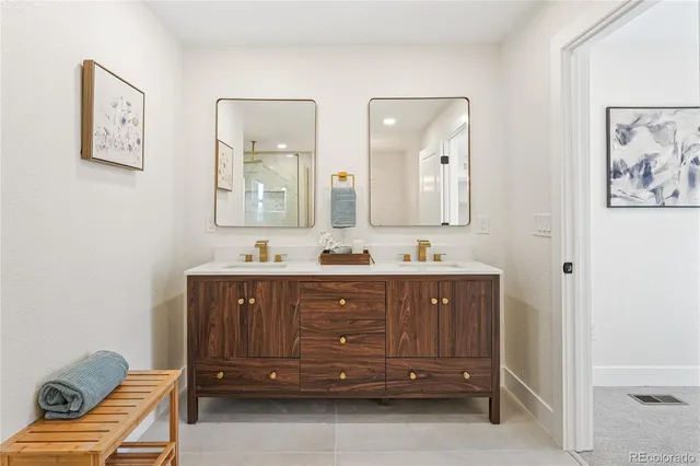 a bathroom with a double vanity sink and a mirror