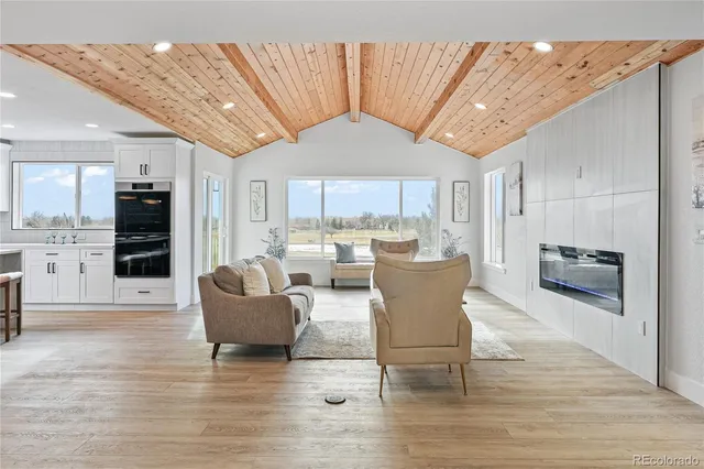 a living room with furniture and a kitchen view