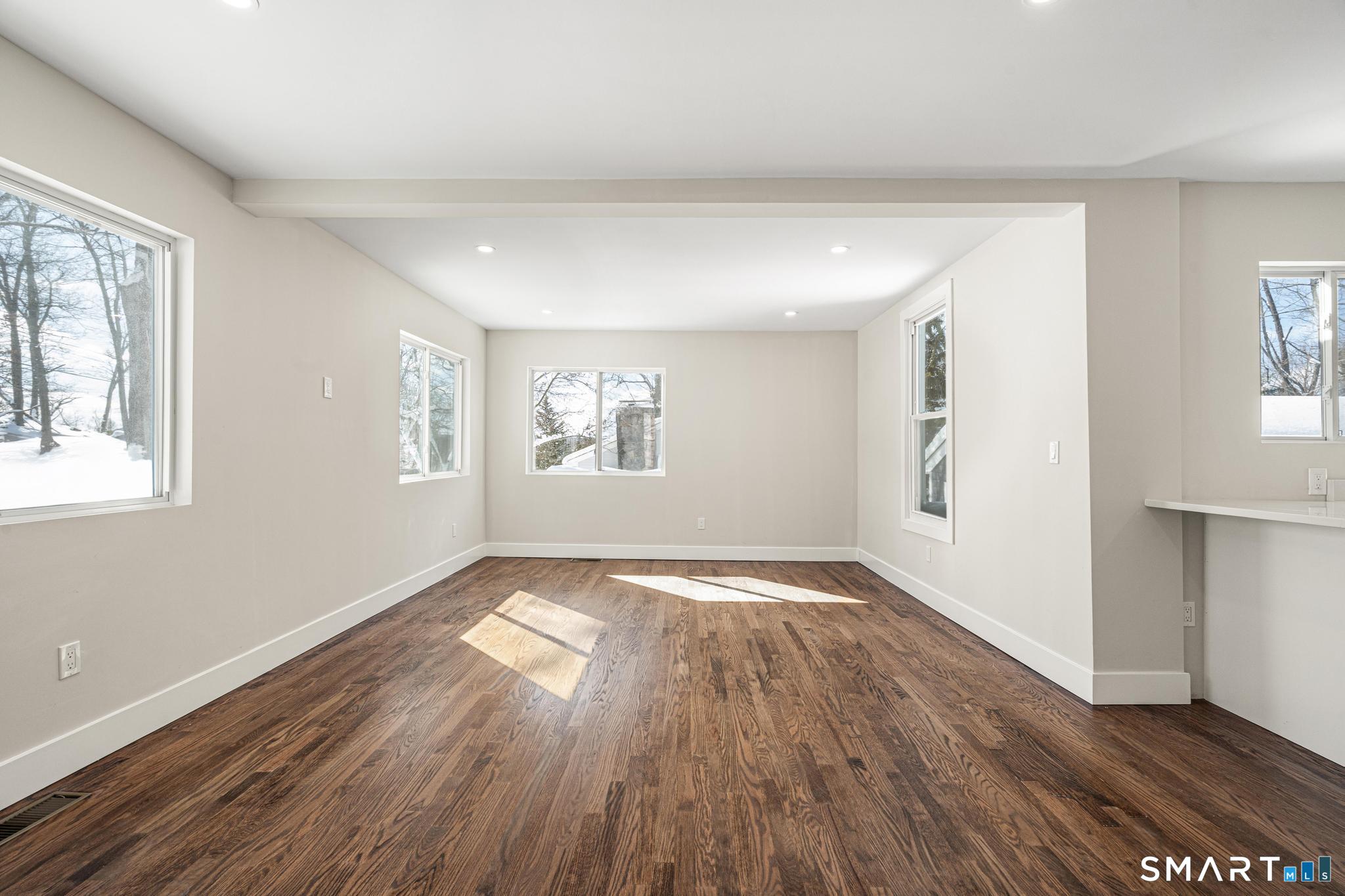 6 Juniper Ridge Drive Danbury, CT 06811 - Photo 9 of 36 an empty room with wooden floor and windows