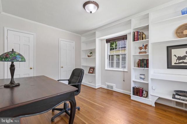 a view of a dining room with furniture a rug and wooden floor