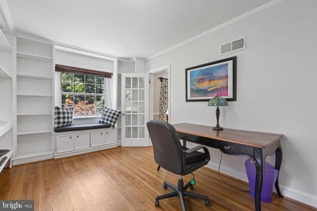 a living room with furniture window and wooden floor