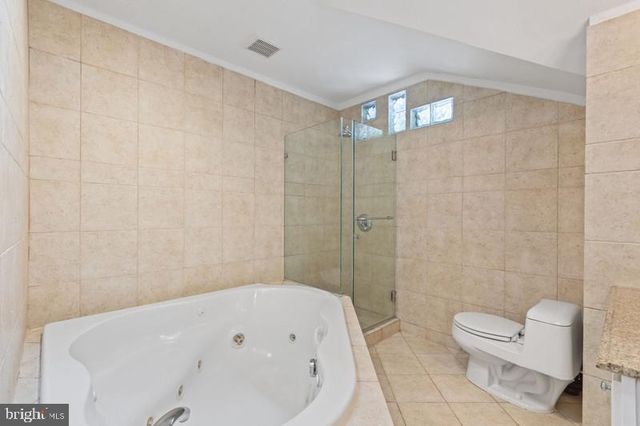 a bathroom with a bathtub and toilet