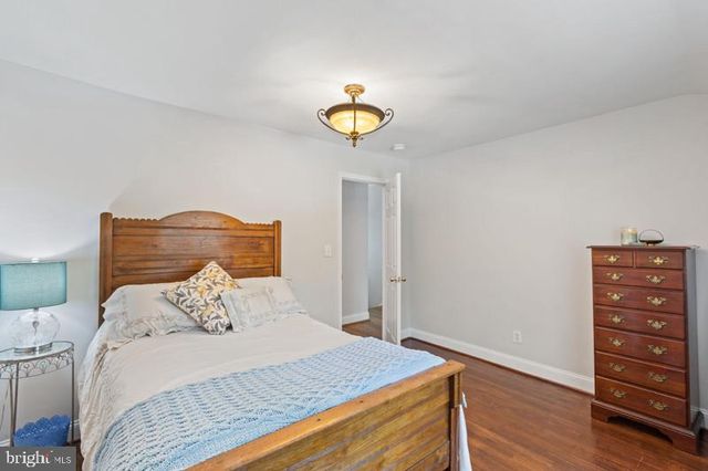 a bedroom with a bed and a potted plant
