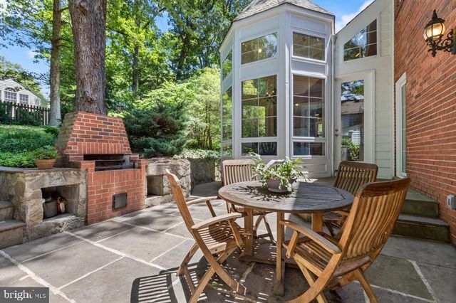 a view of a patio with a table and chairs