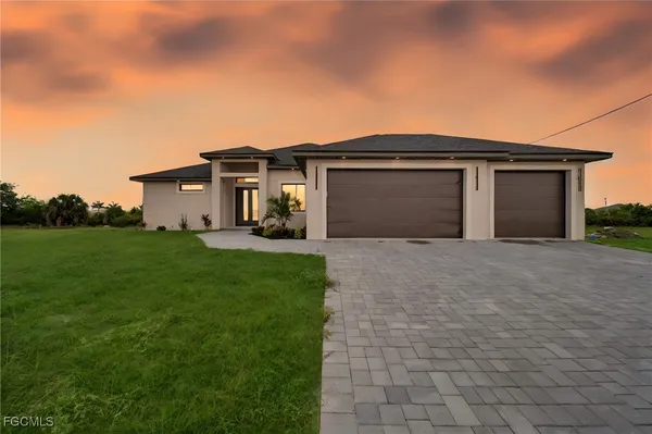 a front view of a house with a yard and garage