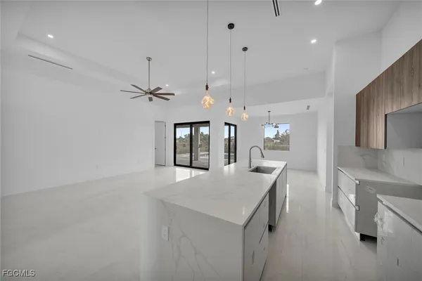 a kitchen with a sink a counter top space and stainless steel appliances