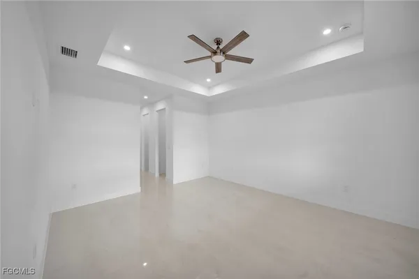 an empty room with closet and ceiling fan