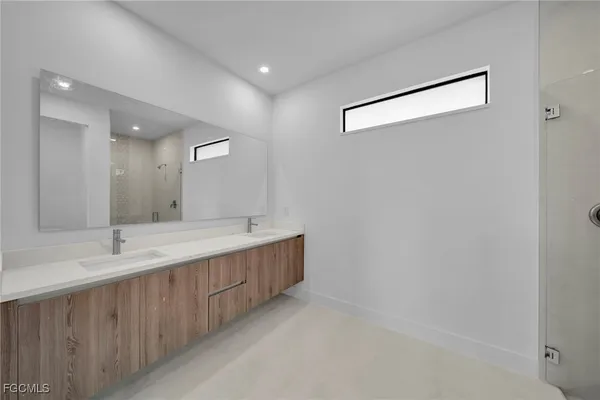 a bathroom with a double vanity sink and a mirror