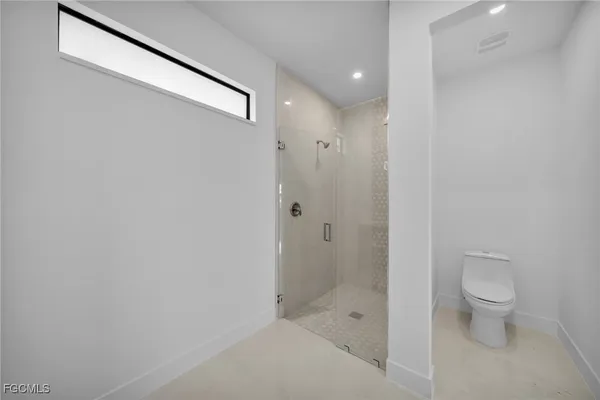 a bathroom with a shower and a toilet
