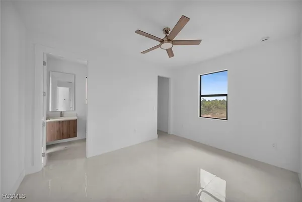 a view of a livingroom with a ceiling fan and window