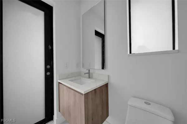 a bathroom with a sink a toilet and mirror